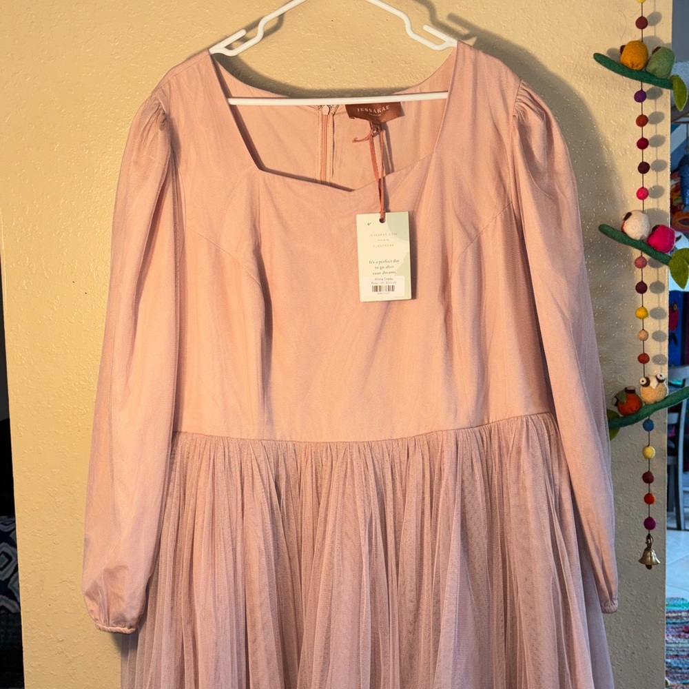 NWT JessaKae Allora Dress in Rose by the brand.
Color: Rose (a dusty pink)
Desi - Picture 2 of 11